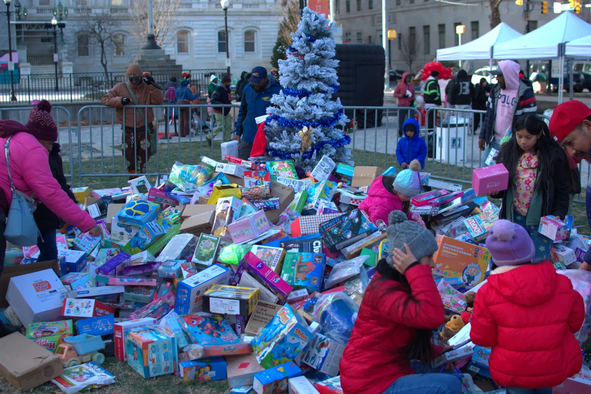 Children selecting toys at the Christmas tree