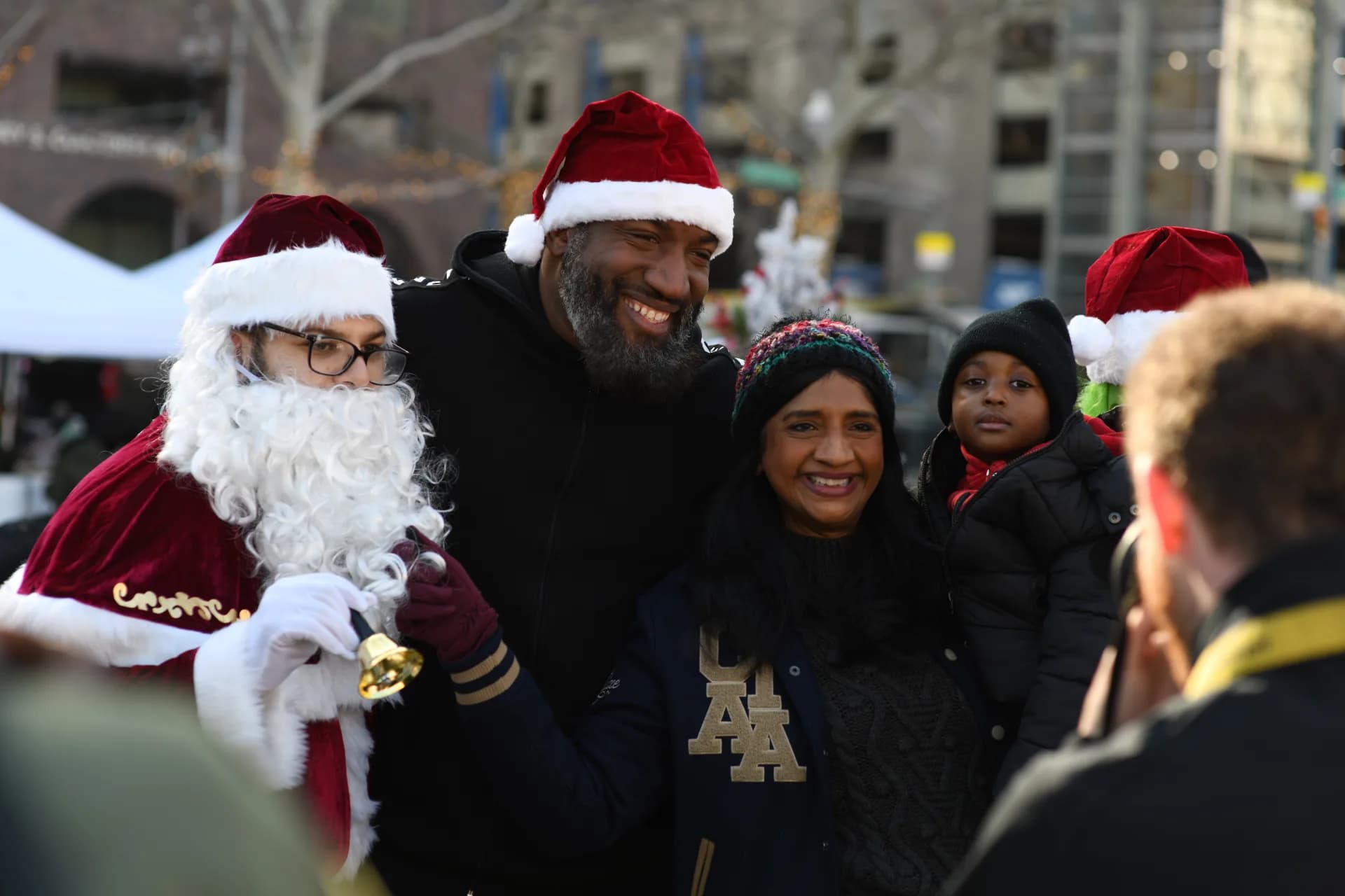 A family posing with Santa Claus at the Christmas Drive